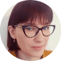 dark haired woman with black glasses